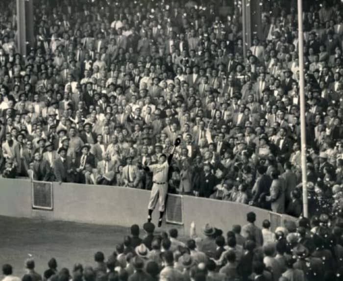 Furillo at Yankee Stadium, 1955 World Series. The wall was much lower then and it was only 299 feet down the line. Can't believe almost everyone in the crowd is wearing a suit.
