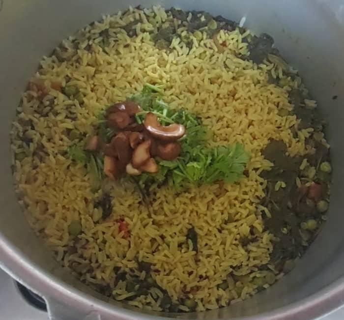 When the pressure subsides, open the pressure cooker and add 1/4 cup coariander leaves and fried cashews.