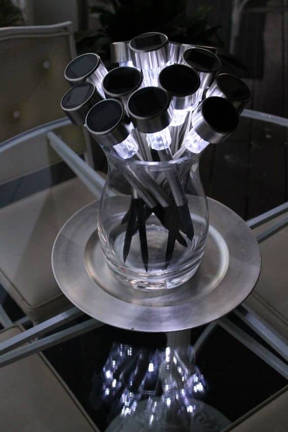 Dollar store solar lights. Create a bouquet of lights in a glass vase for perfect outdoor ambient lighting.