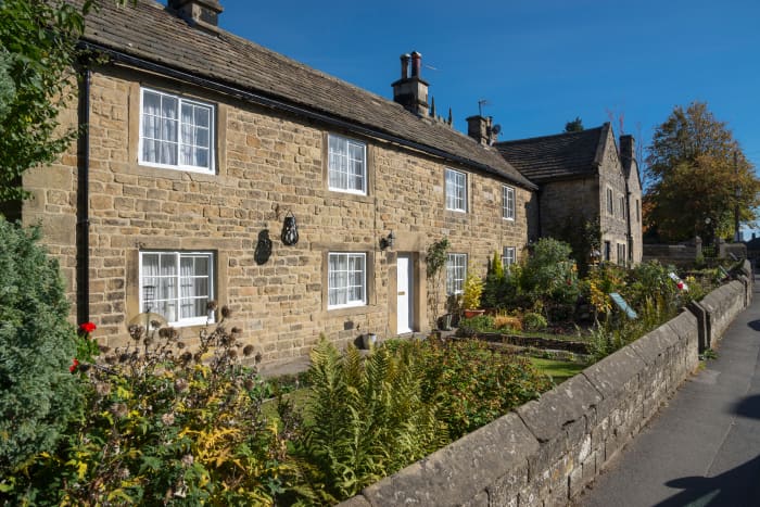 Famous row of cottages in the historic village of Eyam in the Peak District national park. The first victims of a 17th-century plague epidemic died in these cottages.