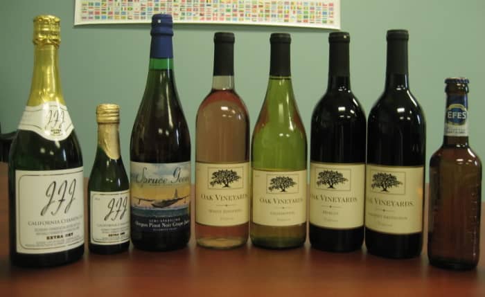(Left to right) JFJ Extra Dry (both sizes), Evergreen Spruce Goose Pinot Noir Juice, Oak Vineyards; White Zin., Chard, Merlot, Cab., Efes Pilsner, photo By MidStateWine - Which is better for you? Beer or Red Wine