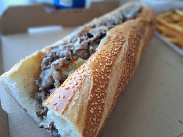 Tender ribeye, caramelized onions, and Cooper sharp American cheese on a seeded roll.