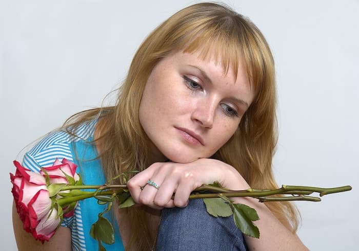 A woman wondering whether or not to accept a Man's gift.