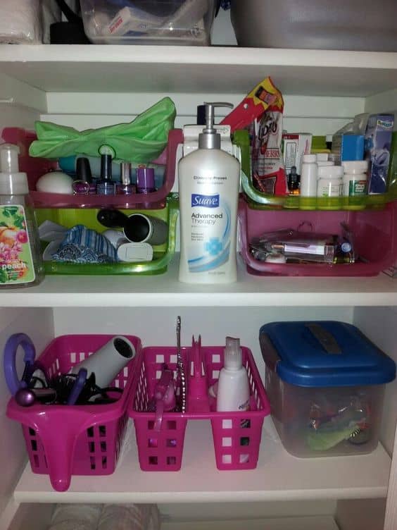 Dollar Tree organization for the bathroom closet. The pink and green bins are all Dollar Tree finds. The ones on the upper shelf have nail stuff, miscellaneous, medicine, and makeup items.