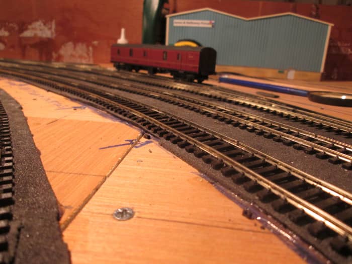 'Bloomfield's Mail Order depot trackwork is down (at last!), leaving the way clear for building and platform structure - Western Region GUV stands in the platform road, we imagine having brought goods for 'sale or return' to the North Riding