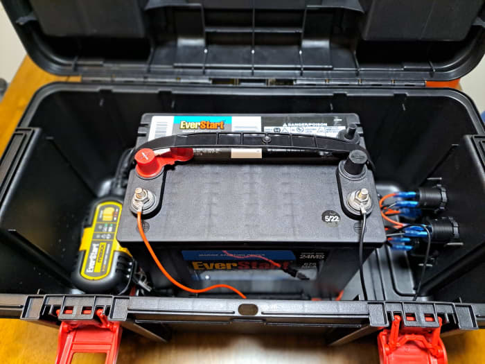 Inside the portable power station is a Group 24 marine battery provided by Walmart and a 12V 3A battery charger.