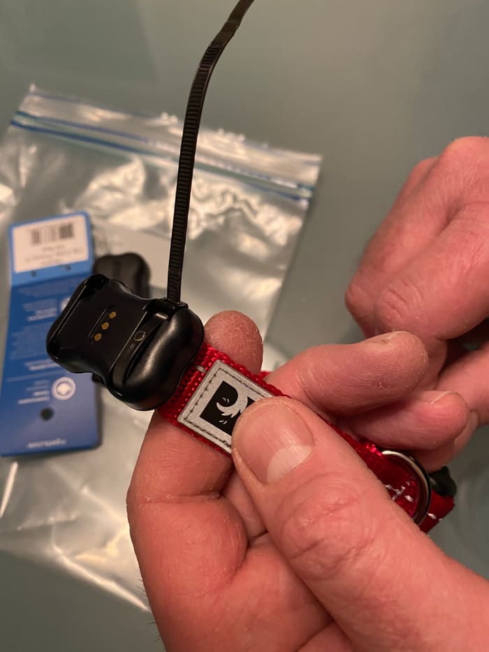 One side is securely attached. You can trim the excess. Try to cut as close to the cable tie head as possible, so the cover will fit nice and snug when you press in on overtop again.