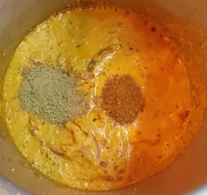 Add ground paste and mix well. Add 1/2 cup water and mix. Add 1 teaspoon coriander powder, 1/2 teaspoon garam masala powder and mix.