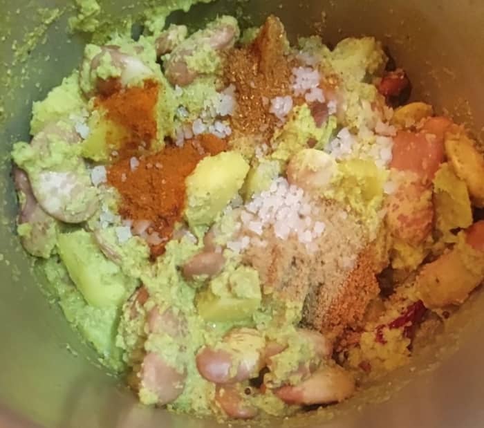 Add 1 teaspoon red chili powder, 1 teaspoon coriander powder, 1/2 teaspoon garam masala powder and salt. Mix well with masala, beans and vegetables.