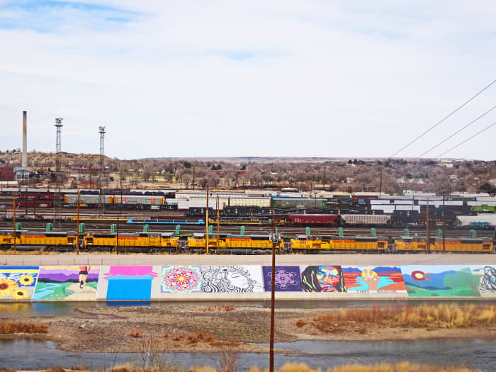 Here is a photo taken from the parking lot of Dutch Clark Stadium which shows several of the murals in one shot.