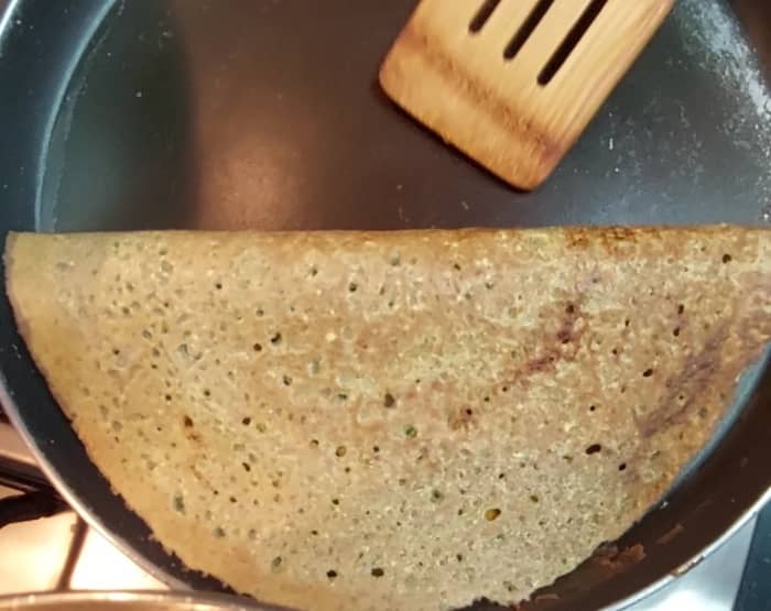 Open the lid and gently press on the. toppings. Remove the dosa from tawa, Serve hot. Repeat the same procedure with the remaining batter.