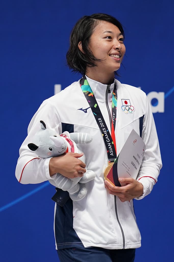Swimmer Satomi Suzuki in this photo celebrates during the 2018 Asian Games in Jakarta, Indonesia as the women won the 100 meter breaststroke event.