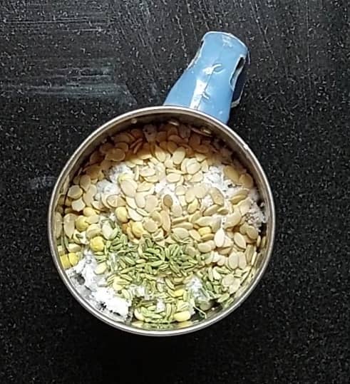 In a mixer jar, add 1 cup grated coconut, 1 tablespoon fried gram, 1 tablespoon melon seeds, 1/2 tablespoon fennel seeds.
