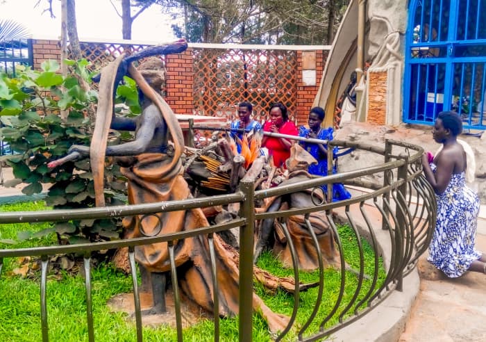 Pilgrims praying to the saints at the site where the martyrs were burnt to death, just outside the basilica