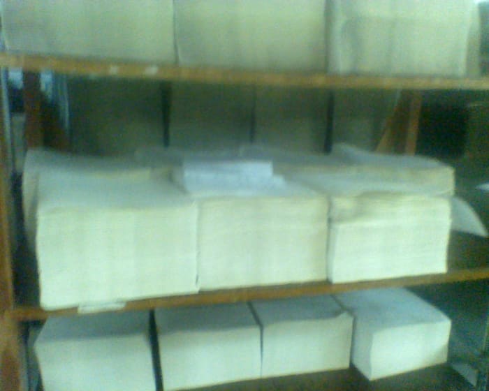 Stacks of embossed sheets on a rack, ready to be collated into books or periodicals.