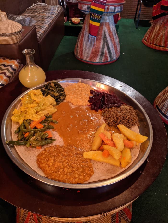 Close up of the platter with our lunch. Yellow globe contains the Tej (Honey Wine) which is served in the round container with the thin neck.