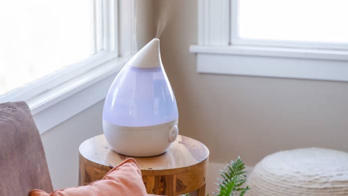 A humidifier is a device that increases the volume of water vapor in the air in a living room indoors.