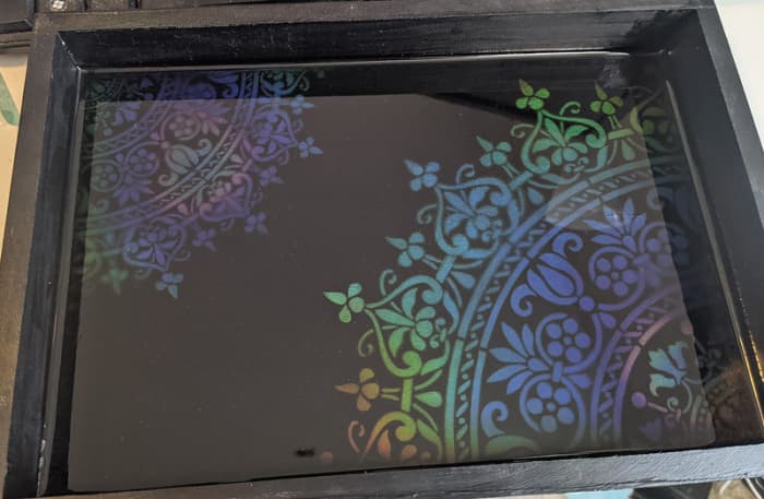 It can be difficult to capture the color changes in a picture, but I also made a tray by airbrushing over a stencil and coating in resin. You can get the effect here in the morning sun.