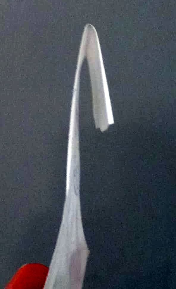 Fold about a 1/4" over the back of each piece of paper. This will enable it to hold onto the cord or wire that you will attach the papers to.