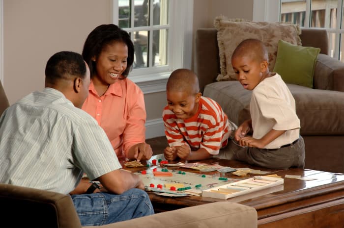 Family game and movie nights at home are a great way to chill out together on a budget.