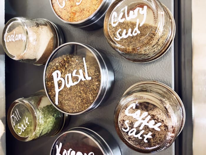 We wanted to make our new spice storage magnetic so that it could be attached to the side of a cabinet, and we found these adorable transparent containers so that you can see how much of each spice you have on hand.