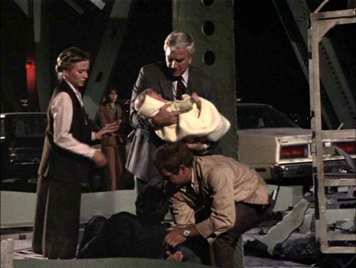 Terry (Eve Plumb) gets ready to take Paul's (Leslie Nielsen) sick baby from him as Cal Miller (James MacArthur) attends to fallen police officer Harvey Lewis (Richard Gilliland) before putting him in the Breeches bouy as Dee (Char Fontane) looks on
