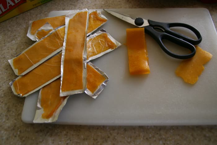 Storing fruit leather in convenient "to-go" packages makes packing lunches easy and prevents the fruit leather strips from sticking to each other.