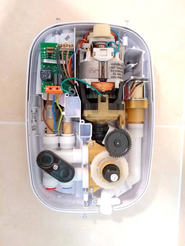 Inside the shower unit. The cable supplying power can be seen. The brown core is live and blue is neutral. These are European Union (EU) and UK wiring colours.