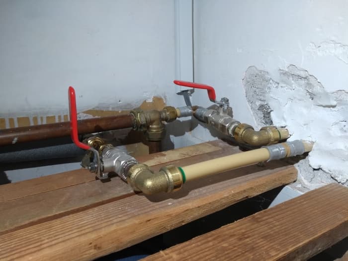 Turn off the water supply. These are quadrant valves or ball valves and usually set to the off position by turning the handle perpendicular to the pipe.