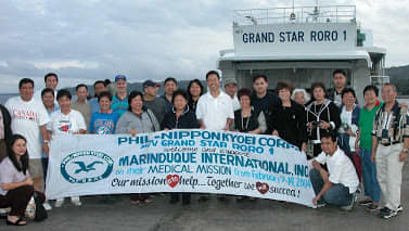 Macrine and I welcoming medical missioners from US and Canada from ferry boat from Manila to Marinduque, 2011