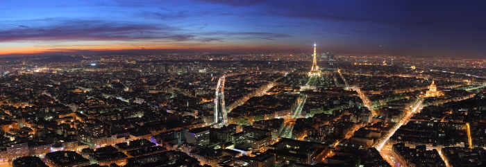 Paris at dusk. The Eiffel Tower can be seen near the centre of the screen. Note the reality low-rise nature of the buildings. Photo by Benh LIEU SONG and distributed under GNU Free Documentation License Version 1.2.