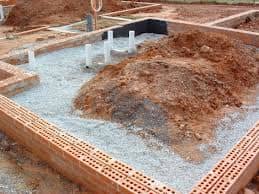 This is a low-set house on concrete floor, the drainage has been done, next it will be back-filled and the soil compacted 50 mm below the concrete floor, then there will be 50 mm of coarse river sand followed by damp course, steel mash and concrete.