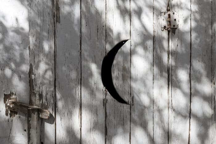 The outhouse doors have cut-outs on them. The crescent moon is for the women, and star cut-outs are for the men.