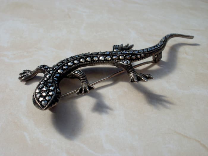 A marcasite silver brooch in the shape of a lizard.