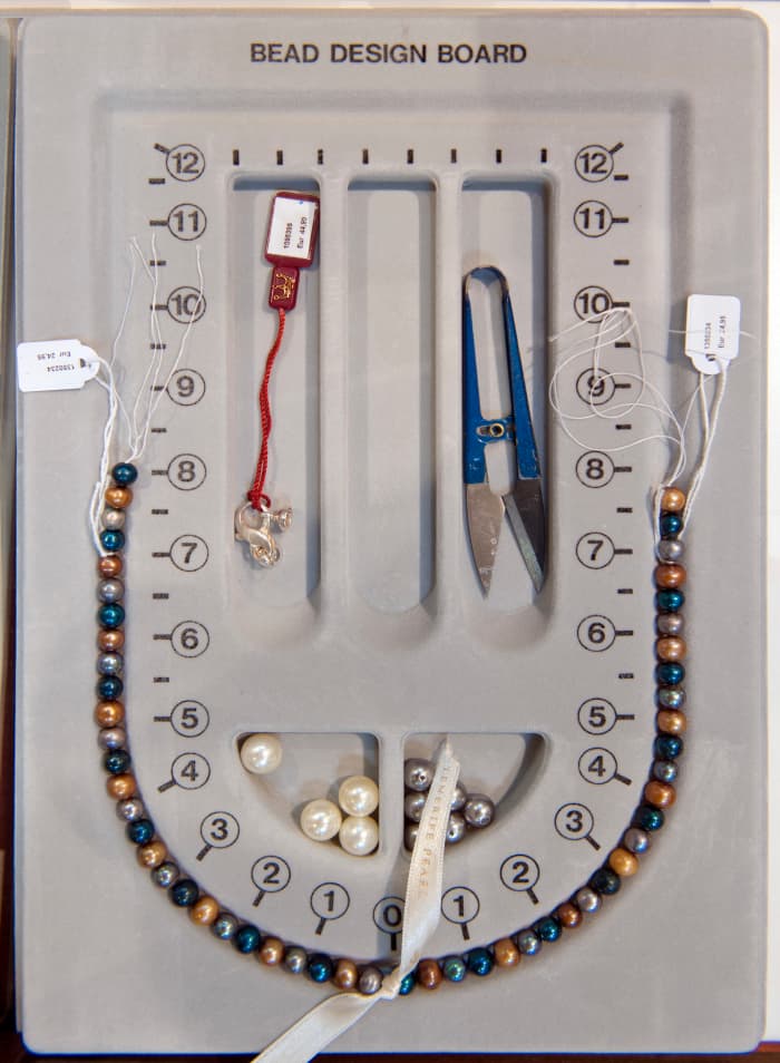 A bead board can be a useful design tool in jewellery making.
