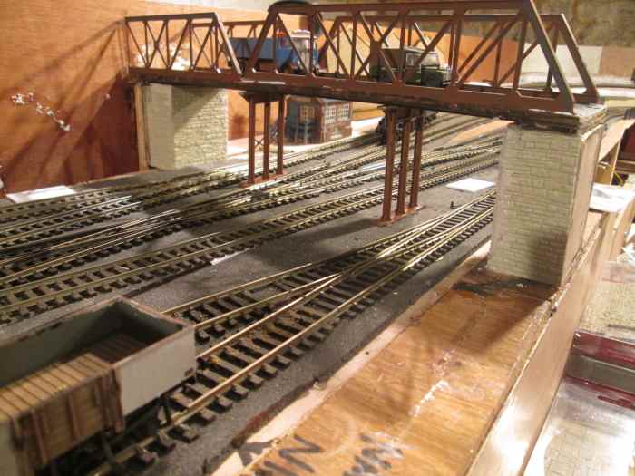 Viewed from the coal depot, Ainthorpe Bank signal cabin seen between bridge piers. Signals on the Up side will be lower down the bank for the 'bobby' (signalman) to see beneath the bridge. On the Down side the signals to be visible to the skew bridge