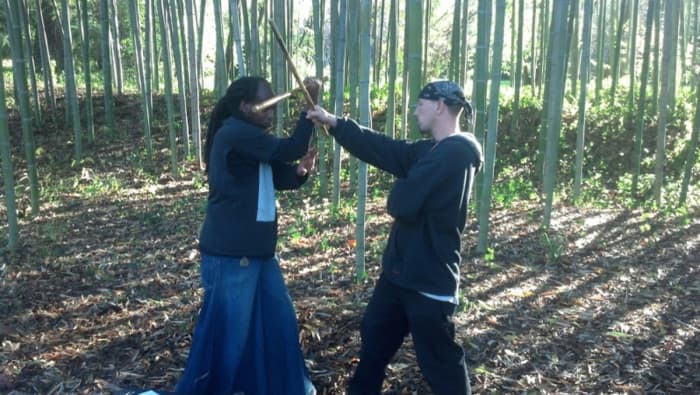 So, Jamie delivers the #2, a high downward diagonal backhand strike, which Glenn catches with a wing block.