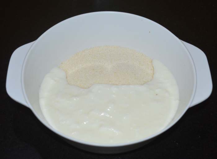 Step one: Make the batter. Add semolina, rice flour, oil, curd, and salt to a bowl. Mix well.