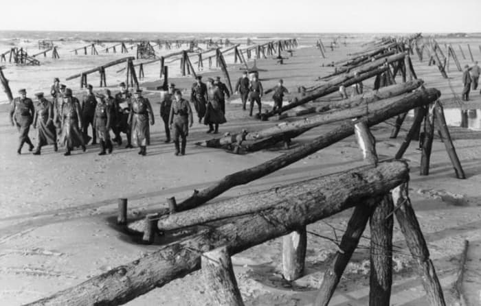 What American troops had to deal with on D-Day. Logs driven into the sand pointing seaward and also capped with mines.