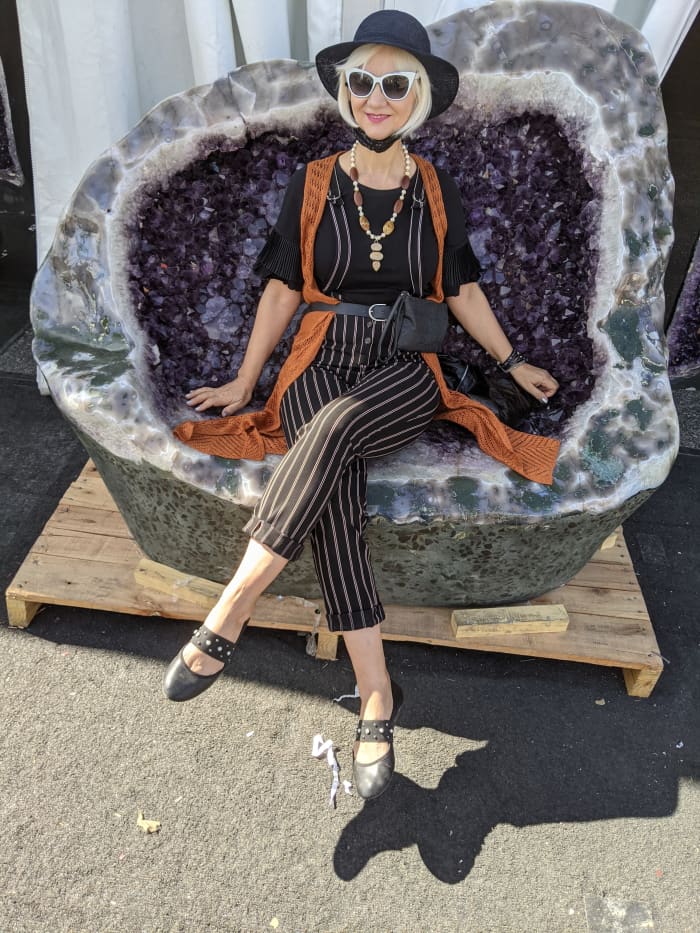 My wife sitting on a giant geode full of amethyst crystals that had grown inside the geode.