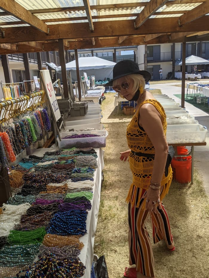 My wife looking through piles of beads seeking ones to make necklaces with
