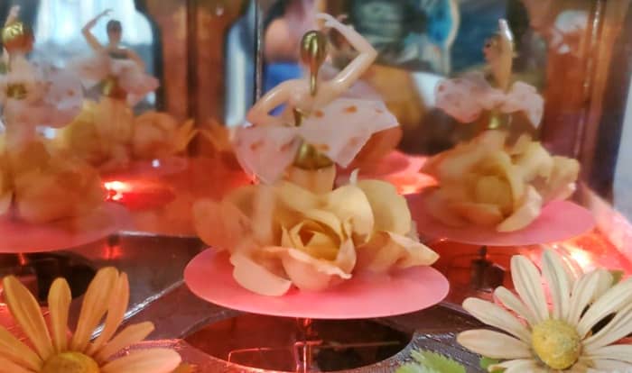 The magical stage inside the jewelry box is a enclosed world of it own. The beautiful dancers appear to be dancing to a audience on a stage in Tokyo.