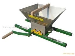 The grapes crushing machine, would be set on a vat and by turning the handle the grapes would be crushed.