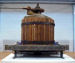 This is very much like the wine press I am talking about, except that there are no cast iron wheels to move it from place to place.