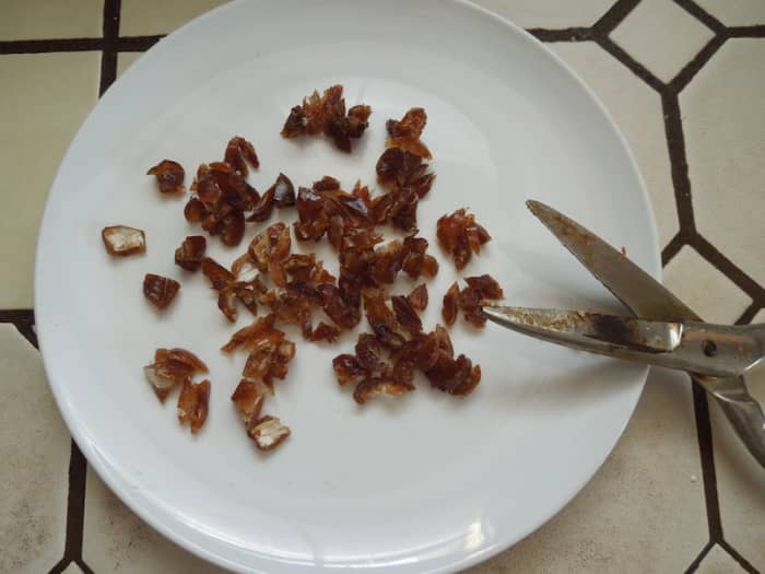 I cut the dates in pieces with scissors into very small pieces. They are sticky and a knife doesn't work as well.