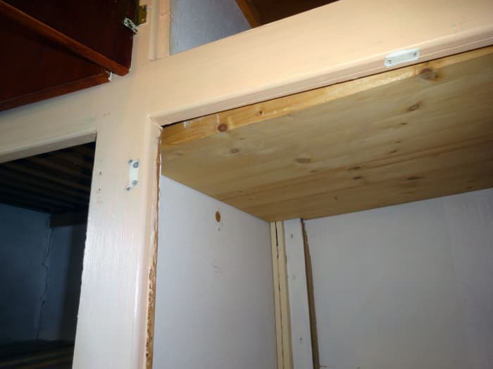 The base shelf of the cupboard above the wardrobe, ready to remove, after its shelf support had been removed from the dividing panel.