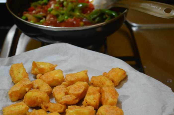 Step three: Heat some oil in a pan. Throw in the onion. Saute it till it becomes transparent. Add fresh peas and bell pepper pieces. Continue to cook for a minute. Add tomato. Continue to cook for one more minute. No need to add water while cooking