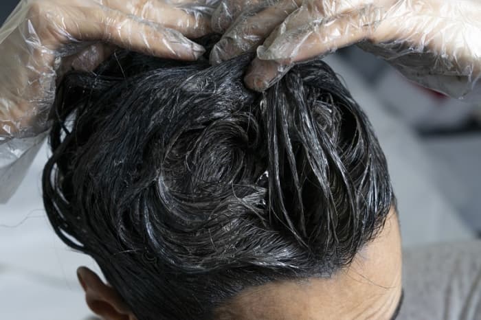 Dyeing your hair darker using an ash shade is one of the ways to neutralize red shades.