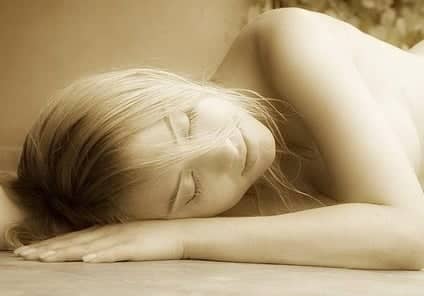 A sleeping woman rests peacefully as she escapes from the concerns of the day.