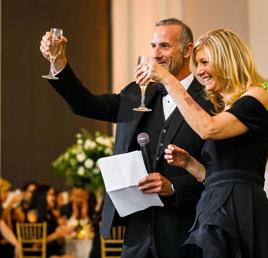 Jewish parents toast their daughter together on her wedding day.
